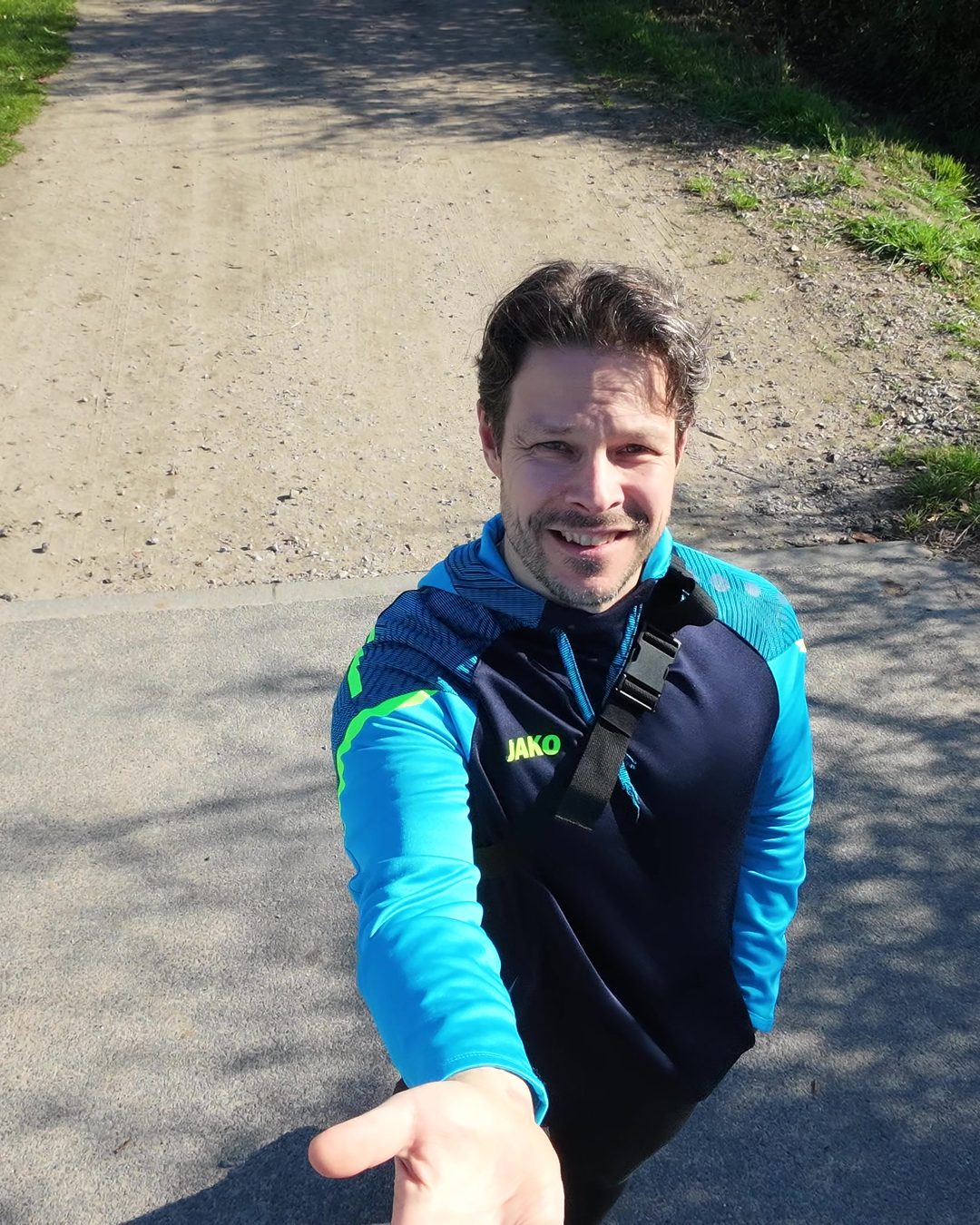 Dirk Gregor auf einem Feldweg im Herbst, lächelt in die Kamera